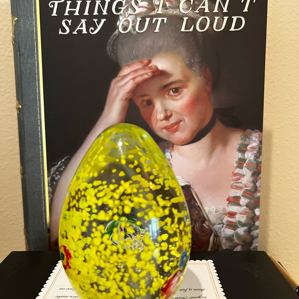 Art Glass Paper Weight with hand blown yellow, red and blue flowers.